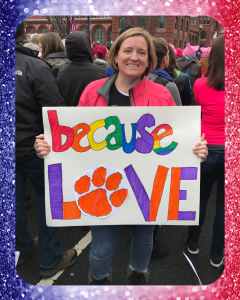 Kasie holding a Because Love sign at the 2017 Women's March