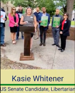 Kasie speaking at a press event