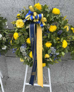 Wreath with navy blue and gold ribbons